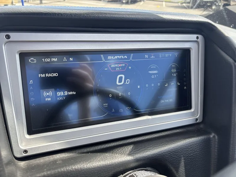 Slide: The Image of 2022 Supra SE 450 dashboard display showing FM radio and navigation details. - 13
