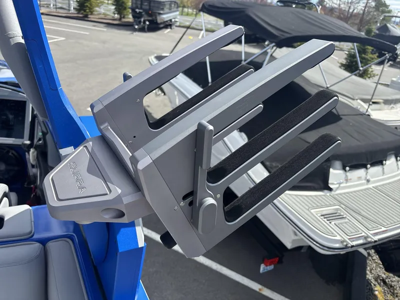 Slide: The Image of 2022 Supra SE 450 boat with a wakeboard rack in a marina setting. - 17