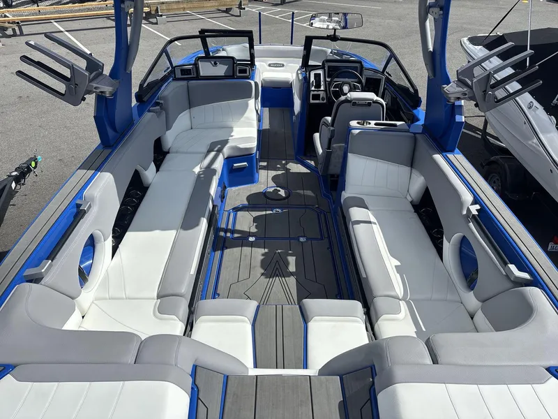 Slide: The Image of 2022 Supra SE 450 boat interior with white and gray seating, blue accents, and modern dashboard. - 6