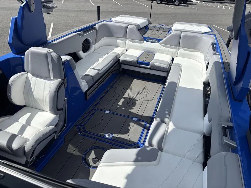 Slide: The Image of 2022 Supra SE 450 boat interior with white and blue seating, spacious layout. - 8