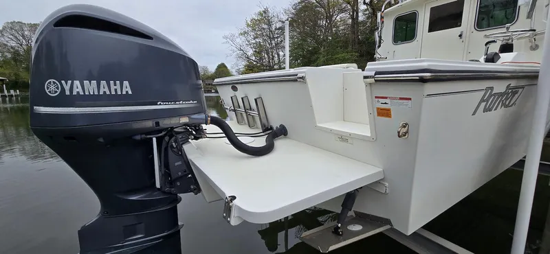 Slide: The Image of 2014 Parker 2520 XLD Sport Cabin with Yamaha outboard motor on calm water. - 19
