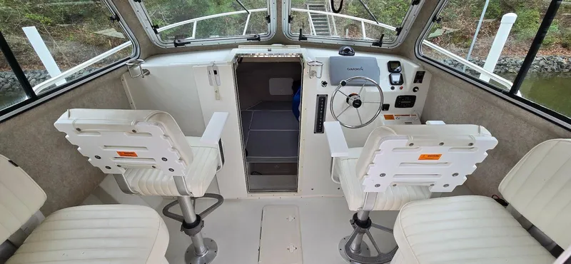 Slide: The Image of 2014 Parker 2520 XLD Sport Cabin interior with helm and seating. - 5