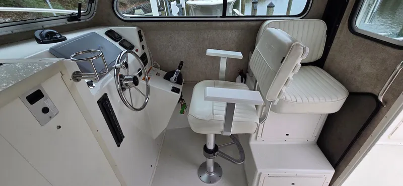 Slide: The Image of Interior of 2014 Parker 2520 XLD Sport Cabin with steering wheel and seating. - 7