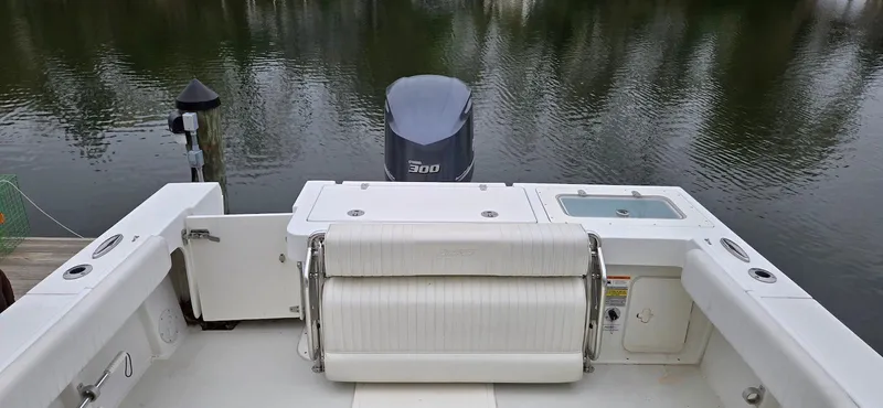 Slide: The Image of 2014 Parker 2520 XLD Sport Cabin boat with outboard motor on calm water. - 8