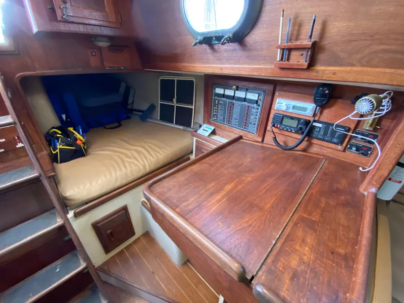Slide: The Image of Interior of 1986 Pacific Seacraft Crealock 37 sailboat with navigation station and seating area. - 10