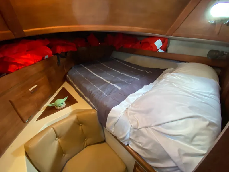 Slide: The Image of Cozy cabin interior of 1986 Pacific Seacraft Crealock 37 sailboat with bed and seating area. - 11