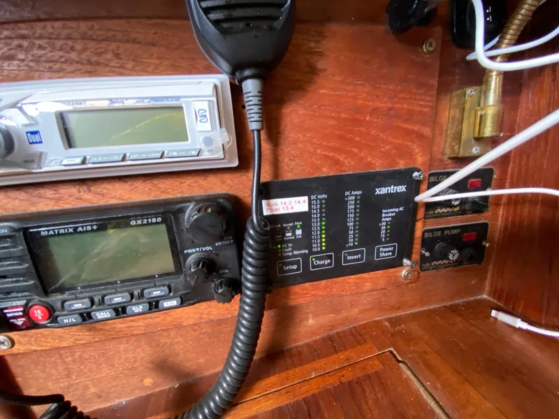 Slide: The Image of Control panel on a 1986 Pacific Seacraft Crealock 37 sailboat, featuring radio and bilge pump controls. - 17