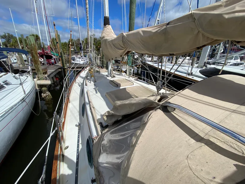 Slide: The Image of 1986 Pacific Seacraft Crealock 37 sailboat docked at marina, view of deck and rigging. - 24