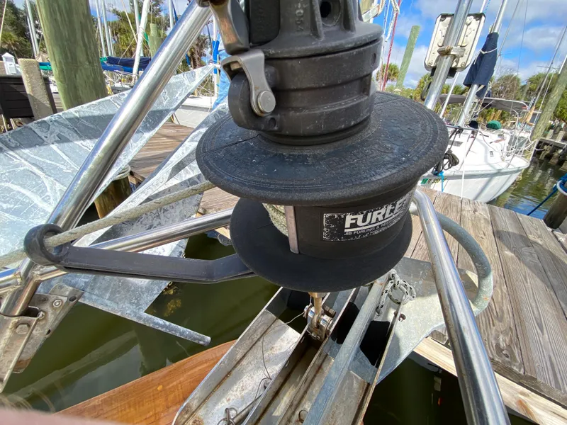 Slide: The Image of 1986 Pacific Seacraft Crealock 37 jib furling system at a marina dock. - 28