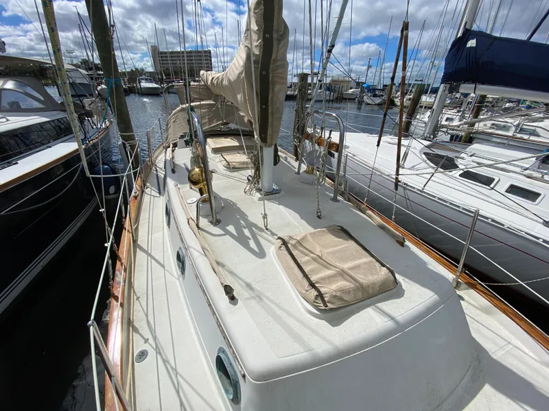 Slide: The Image of 1986 Pacific Seacraft Crealock 37 sailboat docked at marina under cloudy sky. - 29