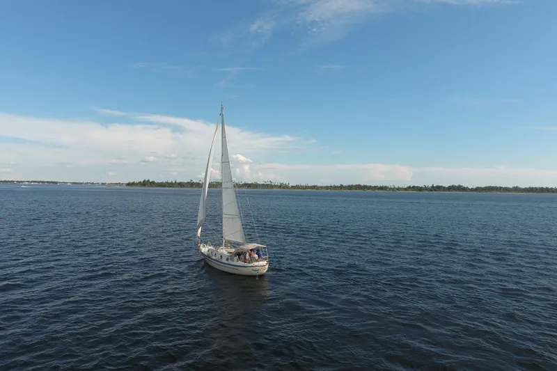 Slide: The Image of 1986 Pacific Seacraft Crealock 37 sailboat cruising on open water under a clear blue sky. - 3