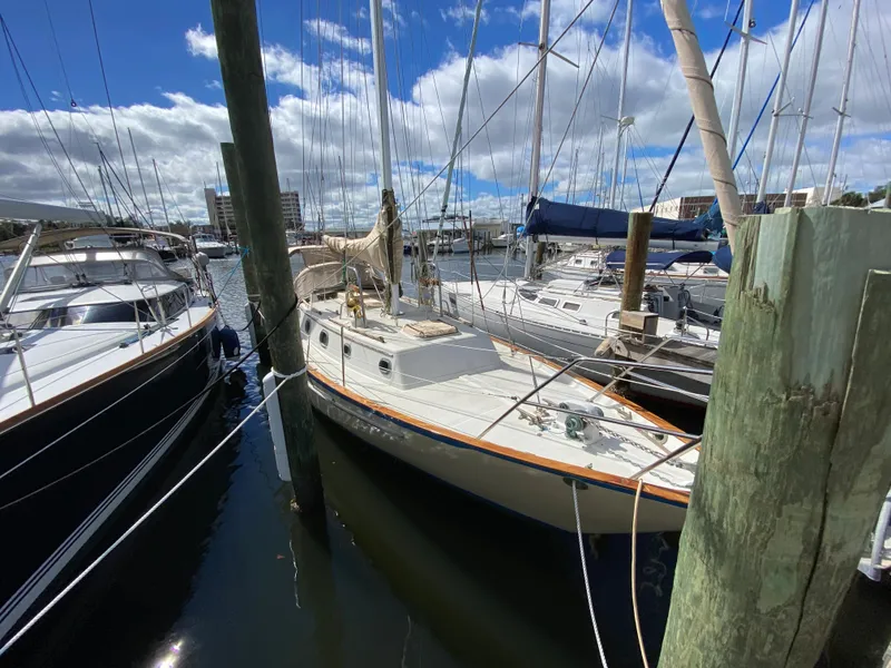 Slide: The Image of 1986 Pacific Seacraft Crealock 37 sailboat docked at marina under blue sky. - 5