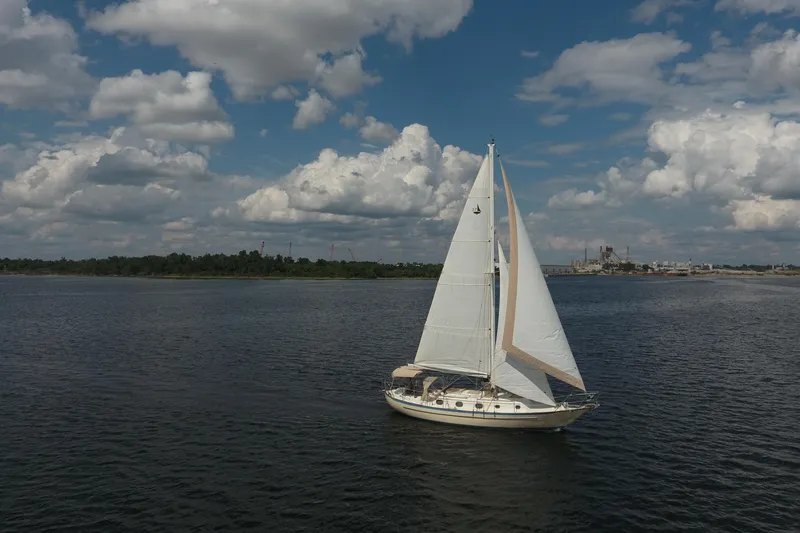 Slide: The Image of Sailboat Pacific Seacraft Crealock 37, 1986 model, cruising on a calm sea under cloudy skies. - 51