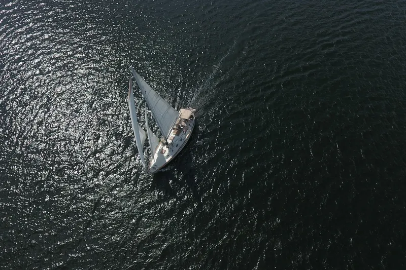 Slide: The Image of Aerial view of 1986 Pacific Seacraft Crealock 37 sailboat navigating open water. - 58
