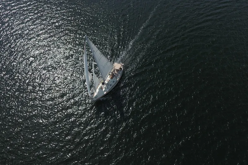 Slide: The Image of Aerial view of 1986 Pacific Seacraft Crealock 37 sailboat navigating open waters. - 59