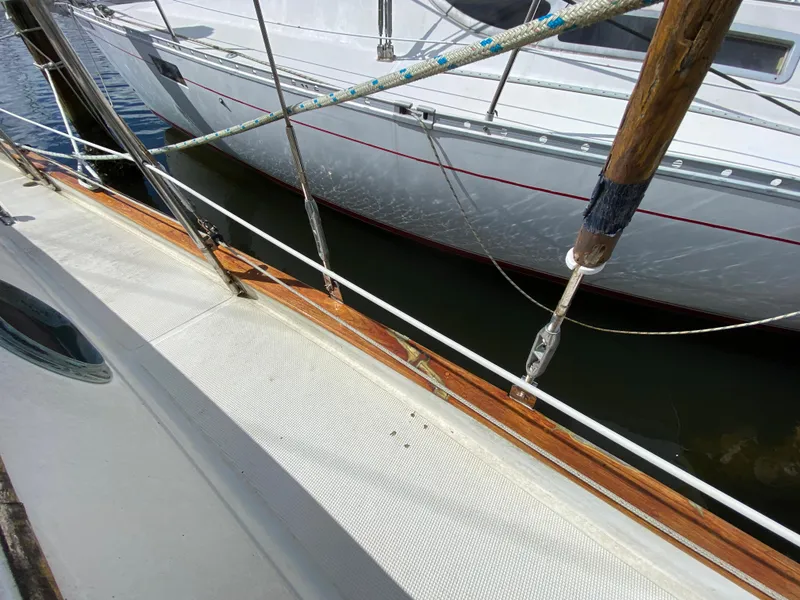 Slide: The Image of 1986 Pacific Seacraft Crealock 37 sailboat deck with railing and adjacent boat. - 6