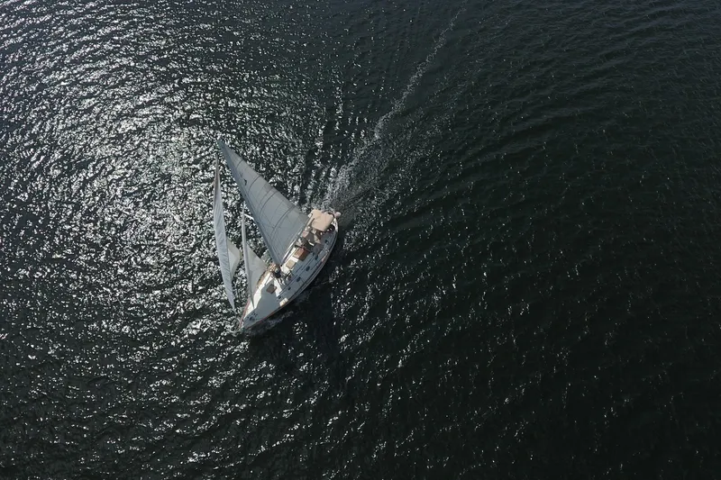 Slide: The Image of Aerial view of 1986 Pacific Seacraft Crealock 37 sailboat navigating open waters. - 60