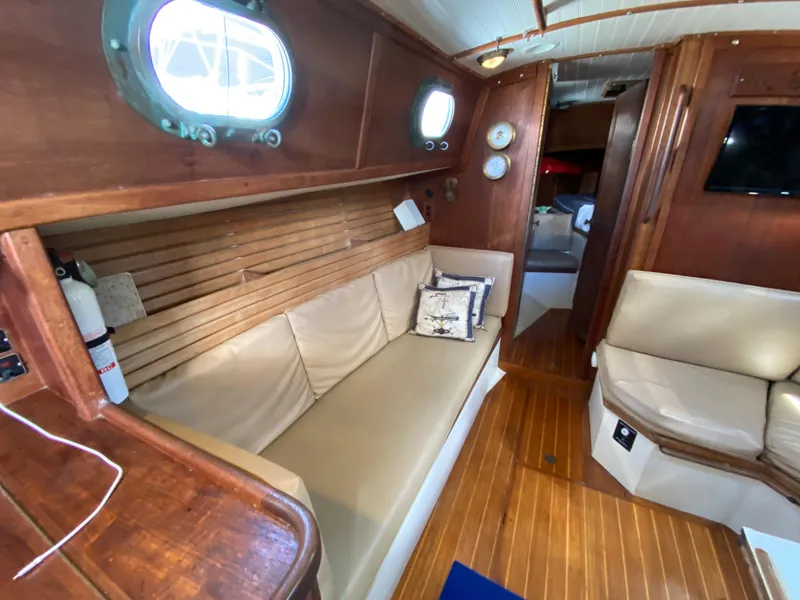 Slide: The Image of Interior of 1986 Pacific Seacraft Crealock 37 sailboat with wooden finish and beige seating. - 9