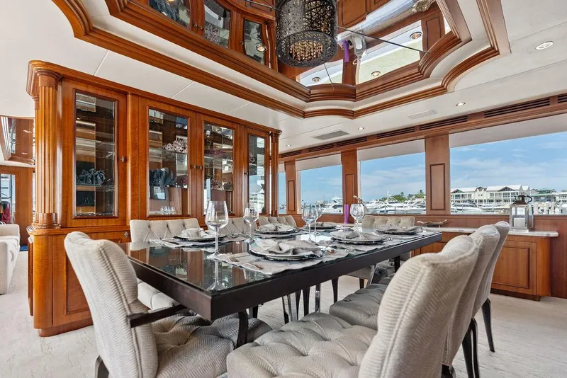 Slide: The Image of Luxurious dining area on a 2004 Hatteras 100 Motor Yacht with elegant wood finishes. - 12