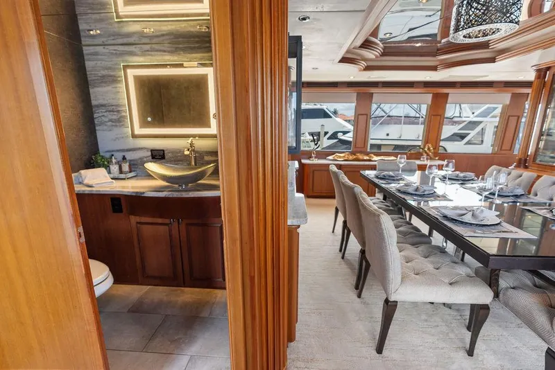 Slide: The Image of Luxurious interior of 2004 Hatteras 100 Motor Yacht with elegant dining area and modern bathroom. - 14