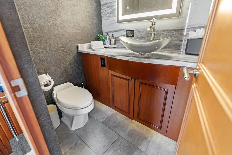 Slide: The Image of Luxurious bathroom in 2004 Hatteras 100 Motor Yacht with modern fixtures and elegant design. - 15