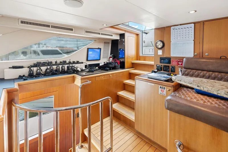 Slide: The Image of Interior of 2004 Hatteras 100 Motor Yacht with wooden finishes and navigation equipment. - 20