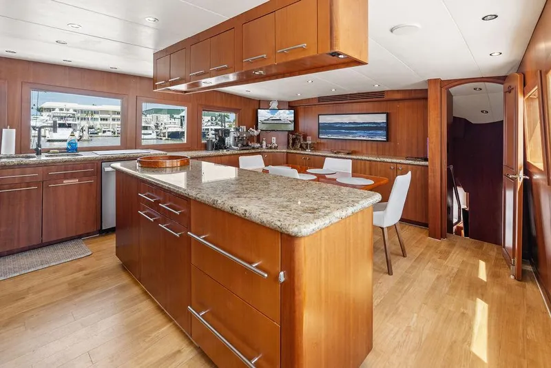 Slide: The Image of Luxurious interior of 2004 Hatteras 100 Motor Yacht with modern kitchen and dining area. - 21