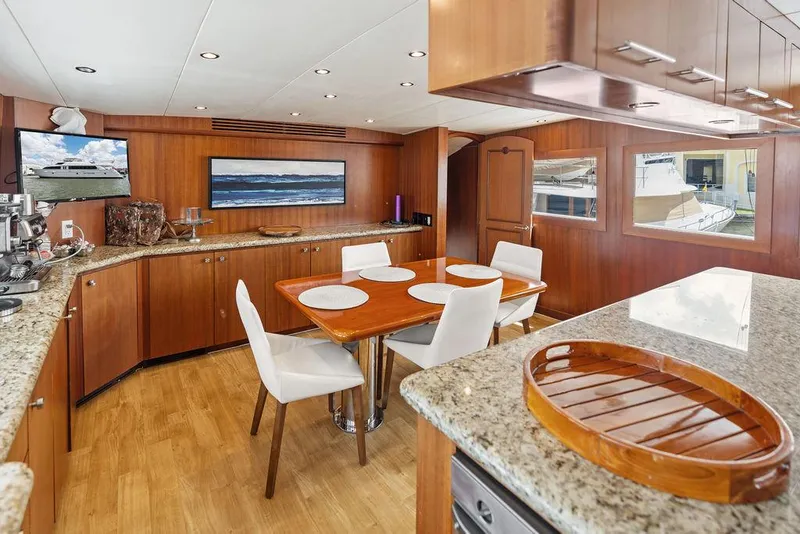 Slide: The Image of Luxurious dining area on 2004 Hatteras 100 Motor Yacht with elegant wood and granite finishes. - 22