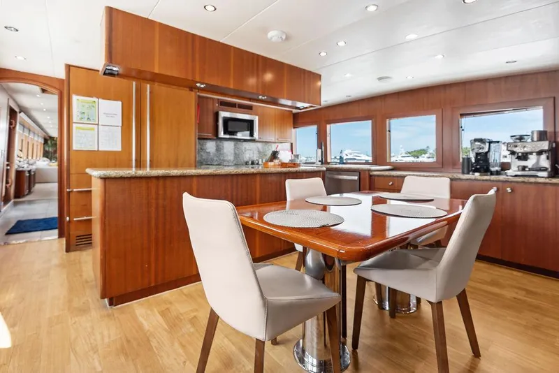 Slide: The Image of Luxurious interior of 2004 Hatteras 100 Motor Yacht with dining area and modern kitchen. - 24