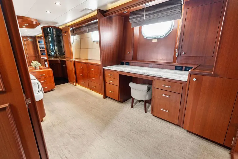 Slide: The Image of Luxurious interior of 2004 Hatteras 100 Motor Yacht with elegant wood cabinetry and desk. - 26