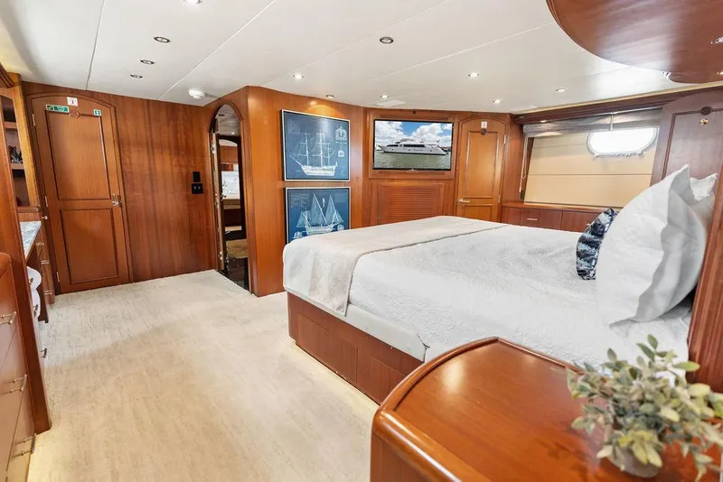 Slide: The Image of Luxurious 2004 Hatteras 100 Motor Yacht bedroom with elegant wood finishes and modern decor. - 30