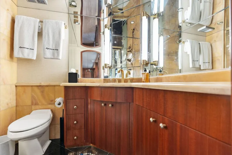 Slide: The Image of Luxurious bathroom in 2004 Hatteras 100 Motor Yacht with wood cabinetry and elegant fixtures. - 31