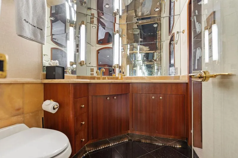Slide: The Image of Luxurious bathroom in 2004 Hatteras 100 Motor Yacht with wood cabinetry and mirrored walls. - 33