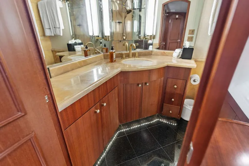 Slide: The Image of Luxurious bathroom on 2004 Hatteras 100 Motor Yacht with wood cabinetry and elegant fixtures. - 35