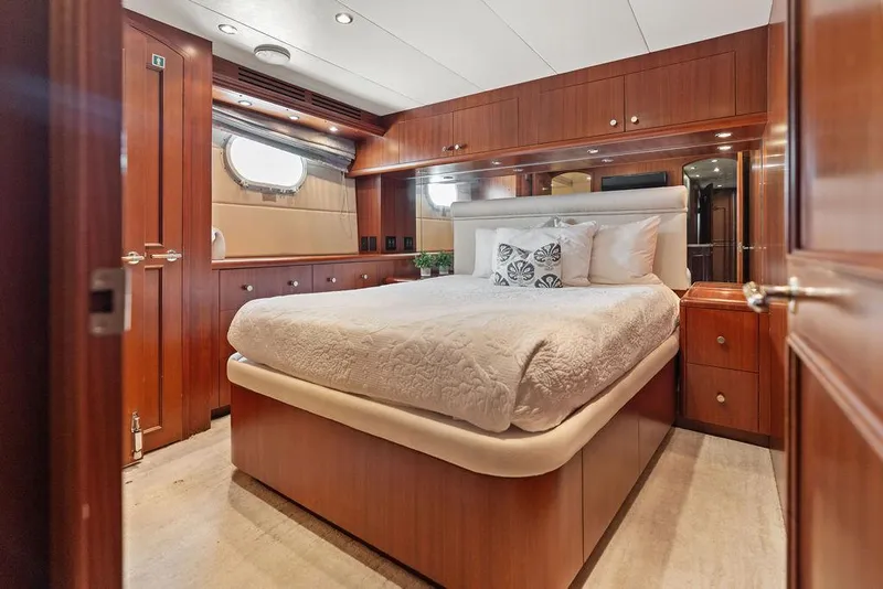 Slide: The Image of Luxurious bedroom interior of 2004 Hatteras 100 Motor Yacht with elegant wood finishes. - 38