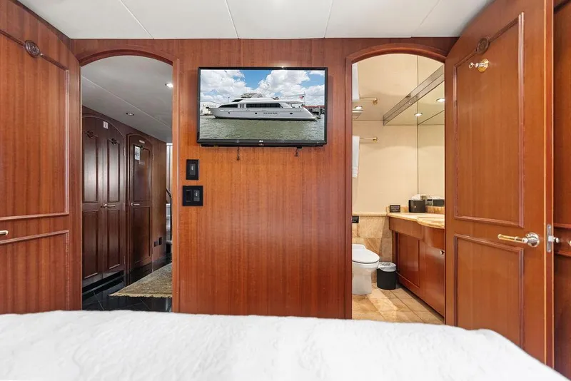 Slide: The Image of Luxurious 2004 Hatteras 100 Motor Yacht interior with wood paneling and modern amenities. - 39