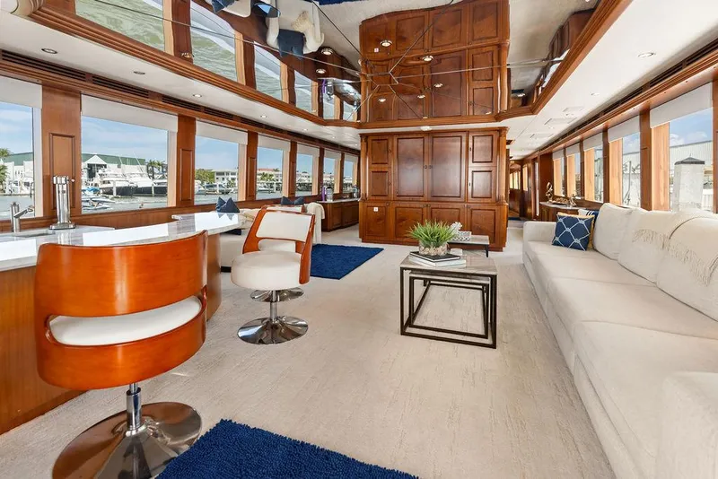 Slide: The Image of Luxurious interior of 2004 Hatteras 100 Motor Yacht with elegant wood paneling and modern furnishings. - 4