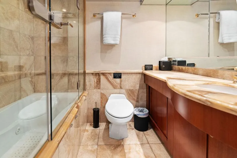 Slide: The Image of Luxurious bathroom on 2004 Hatteras 100 Motor Yacht with elegant marble and wood finishes. - 40