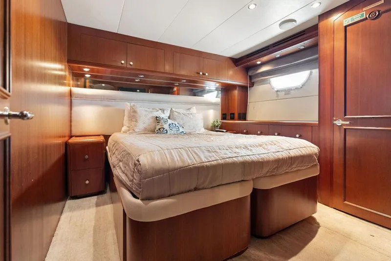 Slide: The Image of Luxurious bedroom interior of 2004 Hatteras 100 Motor Yacht with wood paneling. - 43