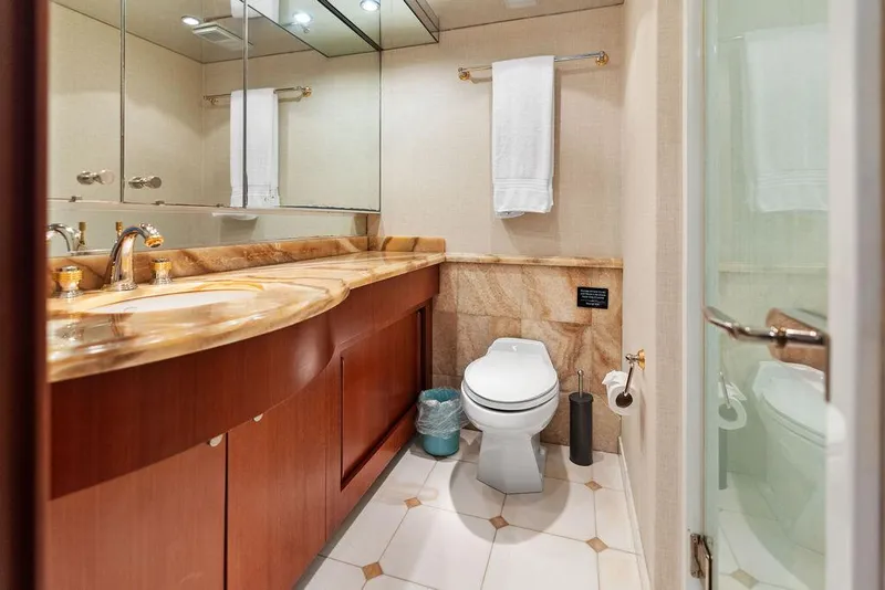 Slide: The Image of Luxurious bathroom in 2004 Hatteras 100 Motor Yacht with elegant fixtures and wood cabinetry. - 45