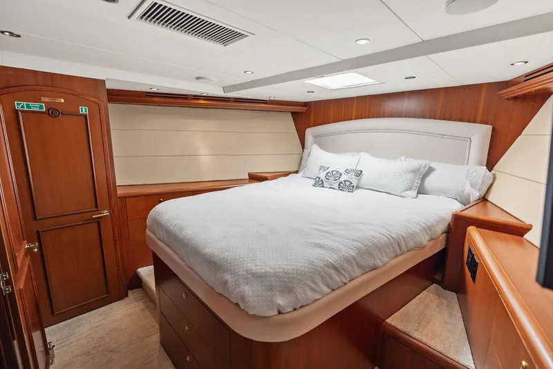 Slide: The Image of Luxurious bedroom interior of 2004 Hatteras 100 Motor Yacht with elegant wood finishes. - 49