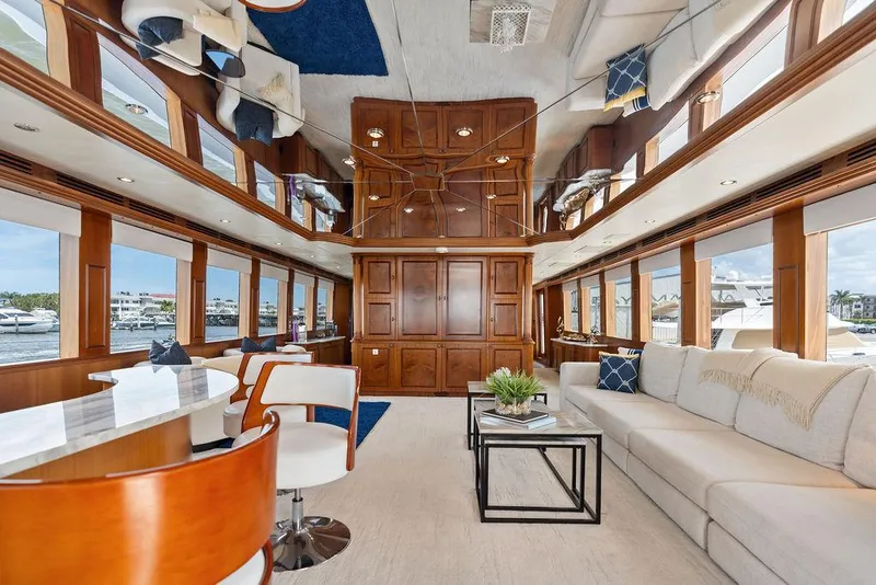 Slide: The Image of Luxurious interior of 2004 Hatteras 100 Motor Yacht with elegant wood paneling and plush seating. - 5