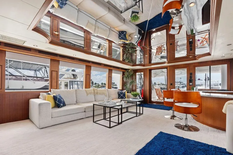 Slide: The Image of Luxurious interior of 2004 Hatteras 100 Motor Yacht with modern furnishings and large windows. - 6