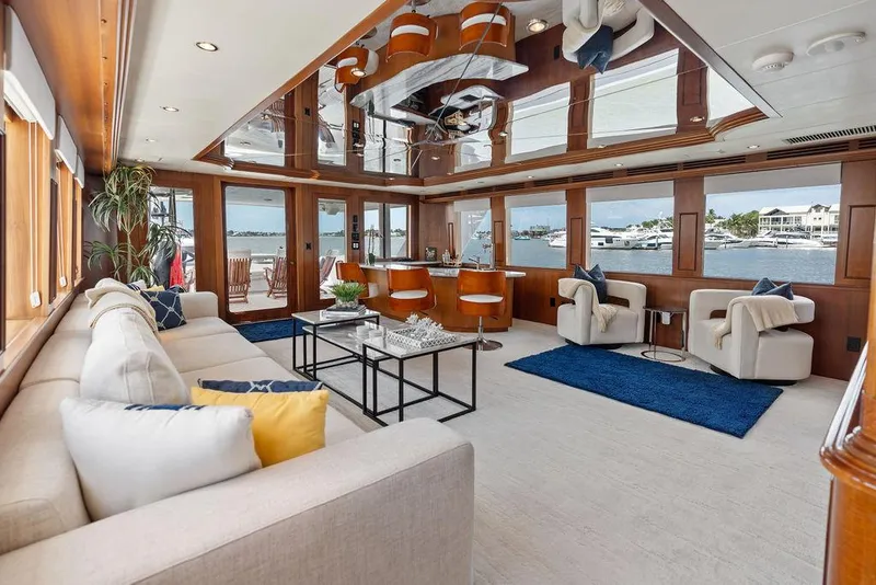 Slide: The Image of Luxurious interior of 2004 Hatteras 100 Motor Yacht with elegant seating and panoramic windows. - 9