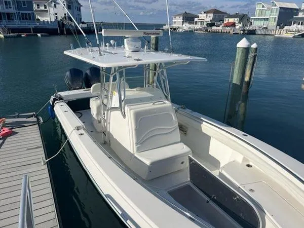 Slide: The Image of 2008 Spectre 34 boat docked in marina, featuring dual engines and spacious deck. - 11