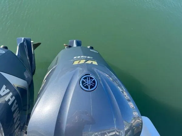 Slide: The Image of Twin Yamaha outboard motors on a 2008 Spectre 34 boat, floating on calm water. - 14
