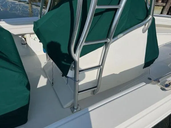 Slide: The Image of 2008 Spectre 34 boat with green covers and metal ladder on deck. - 17