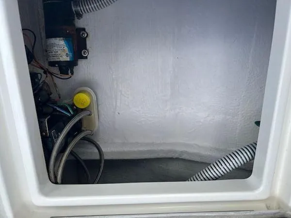 Slide: The Image of Interior view of a 2008 Spectre 34 compartment with wiring and hoses. - 31