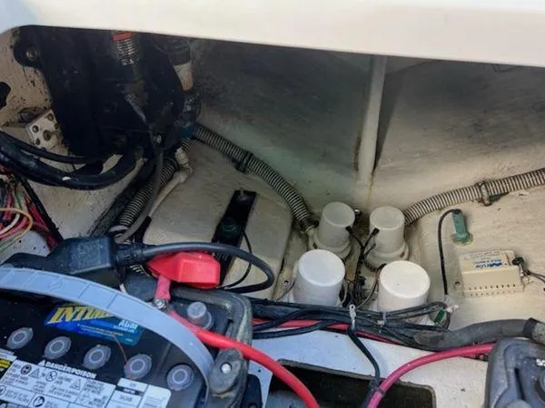 Slide: The Image of Engine compartment of a 2008 Spectre 34 boat, showing battery and wiring components. - 48