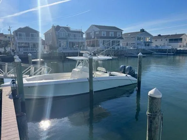 Slide: The Image of A 2008 Spectre 34 boat docked in a sunny marina with waterfront houses. - 9